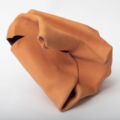 Molded tan leather forming an abstract shape