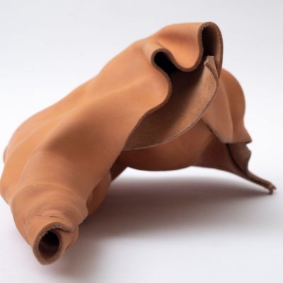 Molded tan leather forming an abstract shape