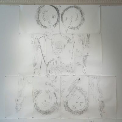 Multiple pieces of paper put together to create an abstracted illustration from a graphite rubbing