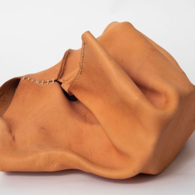 Molded tan leather forming an abstract shape